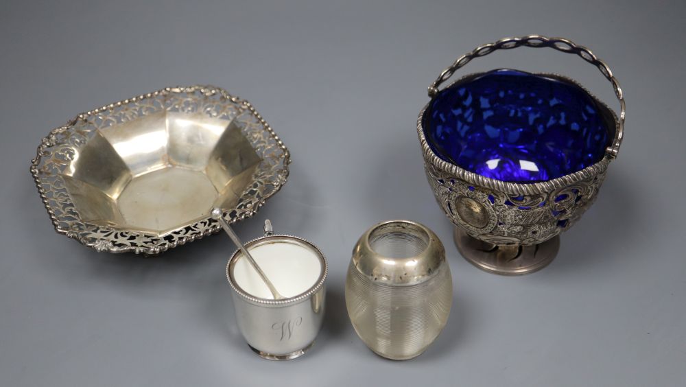 An Edwardian silver sugar basket, George V silver bon-bon dish, silver mounted match strike and a mug salt and spoon (4)
